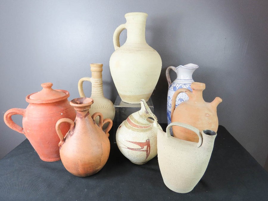 A group of terracotta vases and other ceramics.