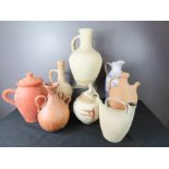 A group of terracotta vases and other ceramics.