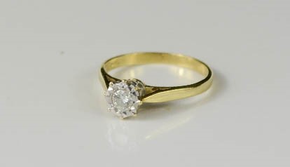 An 18ct gold and diamond solitaire ring, the diamond in a platinum setting, size O, 2.7g.