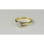 An 18ct gold and diamond solitaire ring, the diamond in a platinum setting, size O, 2.7g.
