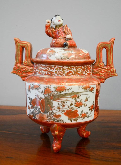 A 19th century Chinese Satsuma style jar, with a cover surmounted by a child with drum, raised on