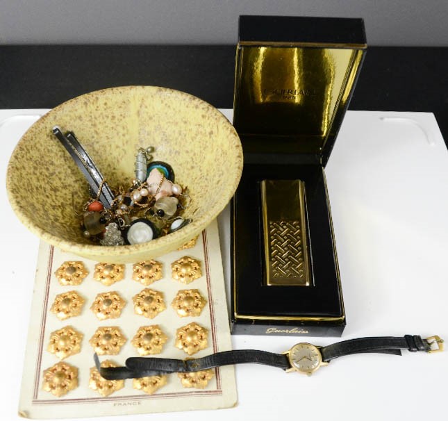 A group of jewellery including a watch, perfume atomiser, and vintage buttons.