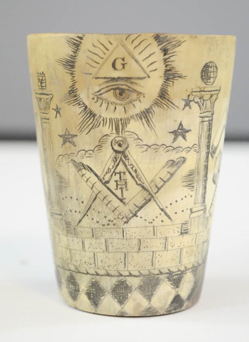 A carved horn beaker, engraved with prisoner of war style decoration,, 7cm high.