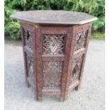 An Indian octagonal top occasional table, carved and pierced with decoration.