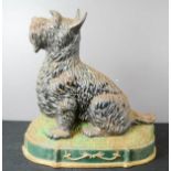 A cast iron door stop in the form of a Scottie Dog.