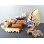 A quantity of collectables, including three model boats, two treen carved boxes, model hand, coconut