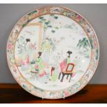 A large 20th century Chinese charger, enamelled with figures in a garden, 40cm diameter.