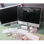 Applemac: two Apple computer screens, together with cables, accessories including keyboards,