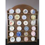 A wall display rack with miniature porcelain plates.