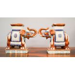 A pair of ceramic elephant form stands, 21cm high.