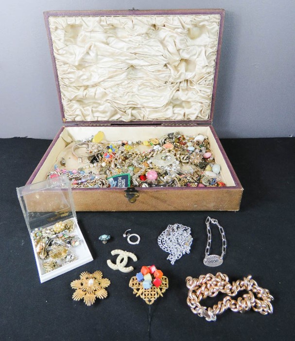 A quantity of costume jewellery in a wooden box.