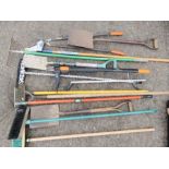 A quantity of garden tools including rakes, brushes, spades, clippers etc.