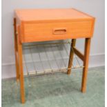A Scandinavian teak side table with a single drawer and wire magazine rack below, 54 by 45 by 30cm.