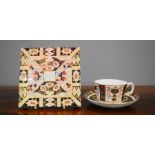 A Royal Crown Derby Old Imari pattern 1128 cup and saucer, and Davenport porcelain stand in the