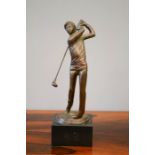 A bronze figure of a golfer, on a slate base, 34cm high.