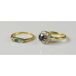 An 18ct gold diamond flowerhead ring, and an 18ct gold diamond and emerald set ring, 5.5g total.