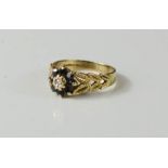 A 9ct gold and paste flowerhead ring, with leaf pattern shanks, 3g.