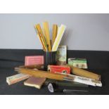 A group of stationary and accessories including rules, paintbrushes, novelty gold club letter