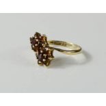 A 9ct gold double flowerhead ring, in smoky topaz, size N, 2.3g.
