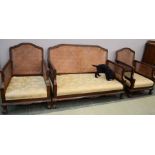 A French Bergere suite, comprising two seater settee and two arm chairs. (lacking cushions)