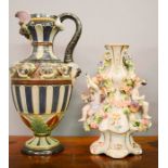 A porcelain bud vase, modelled with cherubs and flowers and a ewer.