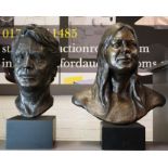 A pair of bronze busts; portraits of man and woman, raised on plinths.