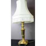 A brass lamp base and shade.