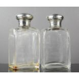 A pair of silver and glass dressing table bottles, London.