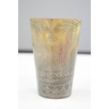 A carved horn beaker, engraved with decoration, 8cm high.