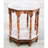 An early 20th century oak octagonal top table, profusely carved with scrollwork, foliage and