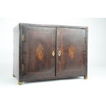 A George III mahogany spice cabinet, the cross banded doors having marquetry ovals depicting urns,