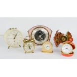 A quantity of clocks, including miniature cuckoo clock, travelling alarm clocks and other examples.