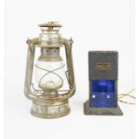 A metal lantern, together with a Chas Hearson & Co Ltd of London lamp with blue glass panel, 17cm