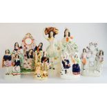 A group of 19th century Staffordshire figure groups including a watch stand and other examples,