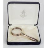 A miniature silver plated magnifying glass, in presentation box.