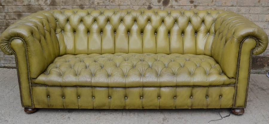 A green leather Chesterfield settee.210 by 90 by 75cm
