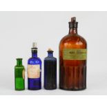A group of antique coloured glass poison and medicine bottles.