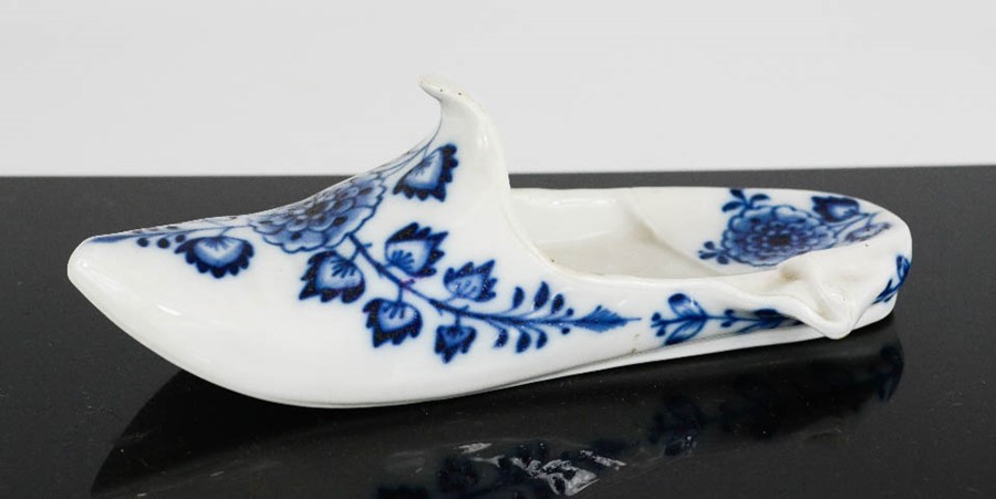 A Meissen blue and white pottery shoe, blue crossed sword marks and no. 62 to the base, 16cm long.