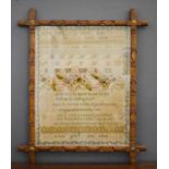 A Victorian sampler, depicting a poem and alphabet, and dated 1880, in a later Arts & Crafts frame.