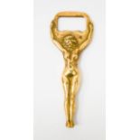 A brass bottle opener in the form of a naked woman, 10cm high.