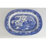 A 19th century meat platter, the Willow Pattern, 42 by 53cm.