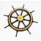 An antique ships wheel, inscribed Prinzessin Eugenie, Hamburg, and to the central brass hub