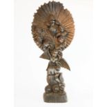 A 19th century carving, depicting an angel with radiating halo of cherub heads above, 32cm high.