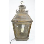 An antique lantern converted to electric together with three copper saucepans.