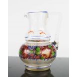 A Victorian German hand painted glass jug, depicting a band of flowers, 13cm high.