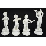 A set of four 19th century white ceramic cherubs playing instruments, tallest 15cm high.
