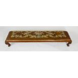 A Victorian long foot stool, with tapestry and velvet upholstered top, raised on short cabriole