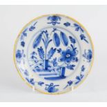 An 18th century blue and white Delft dish, with yellow rim, 16cm diameter.