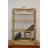A brass parrot cage.