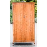 A mahogany compactum wardrobe, with fitted interior including a mirror.